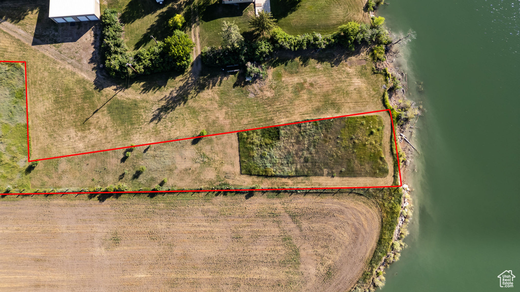 Aerial overview of property's location featuring property parcel outlined and a nearby body of water