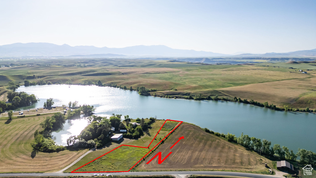 Aerial view of property's location with a water and mountain view and property boundaries highlighted