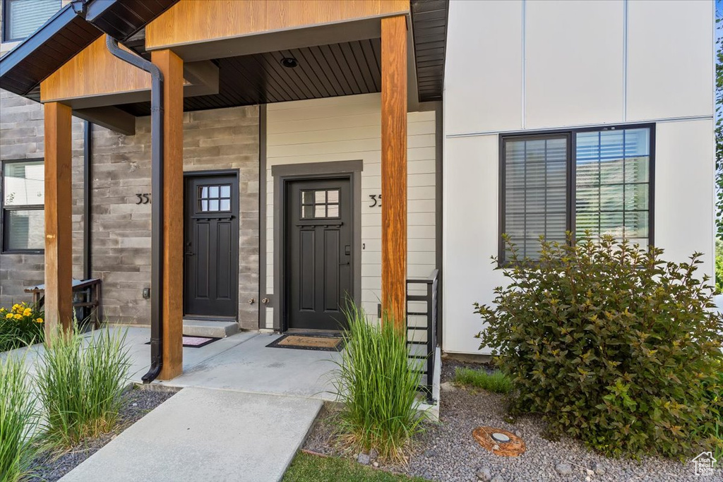 Doorway to property featuring covered porch