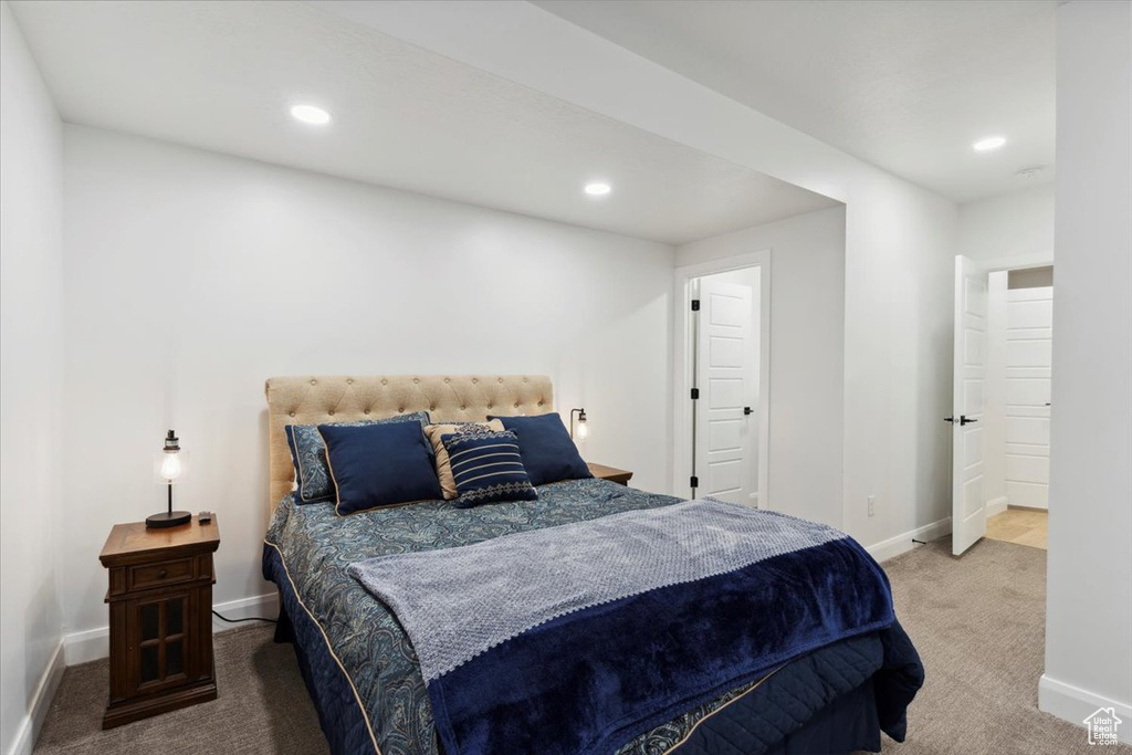 Carpeted bedroom with recessed lighting