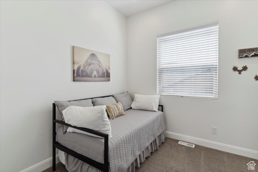 Carpeted bedroom featuring baseboards