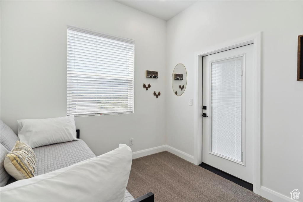 Sitting room featuring carpet flooring and baseboards