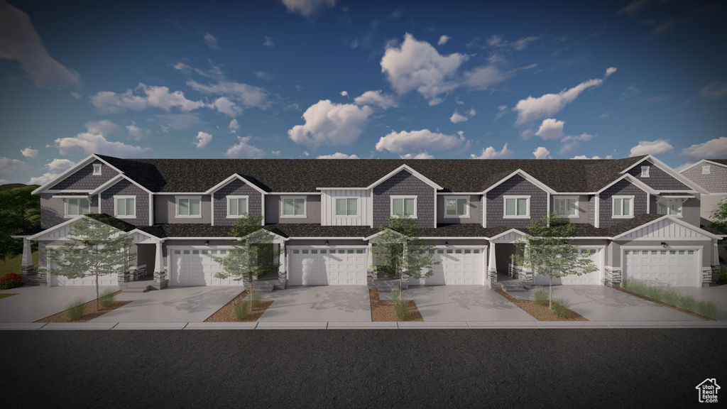 Townhome / multi-family property with driveway, a garage, and a residential view