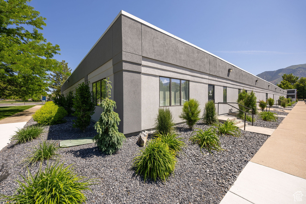 View of property exterior featuring stucco siding and a mountain view