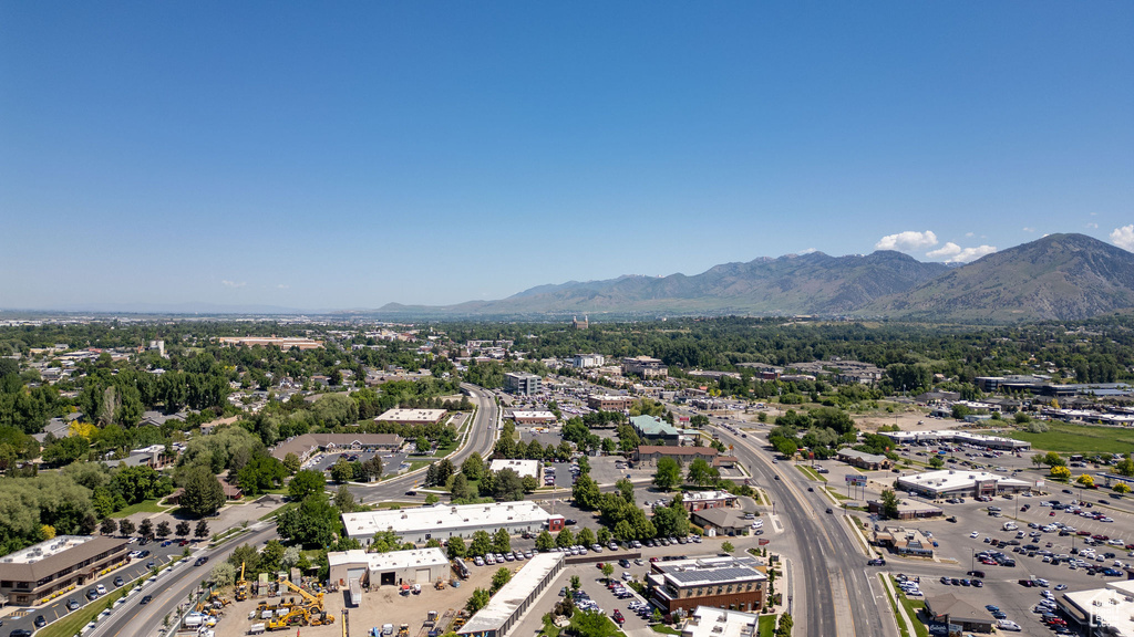 Drone / aerial view of a mountainous background and a highway