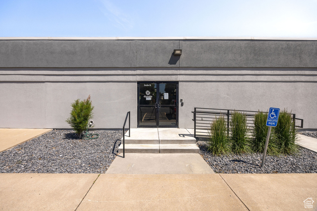 Entrance to property with stucco siding and french doors