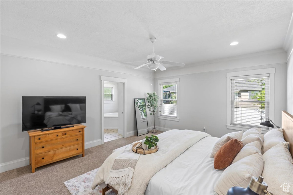 Bedroom featuring light colored carpet, recessed lighting, a textured ceiling, ceiling fan, and ensuite bathroom