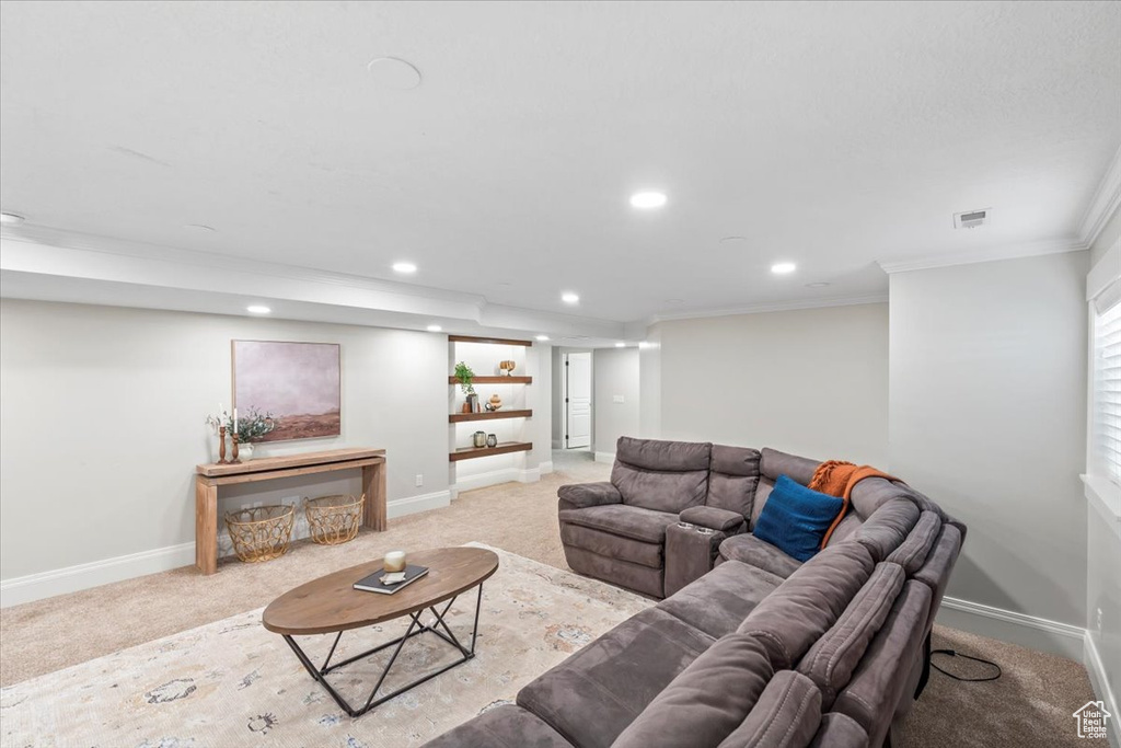 Carpeted living room featuring recessed lighting and ornamental molding