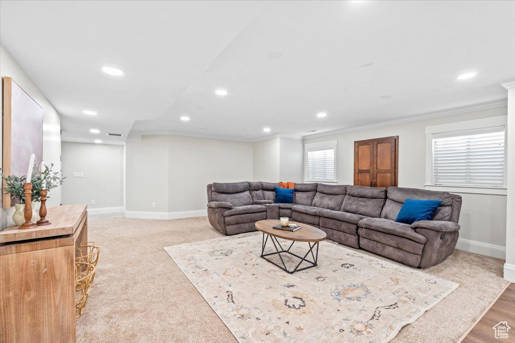 Living area with recessed lighting and crown molding