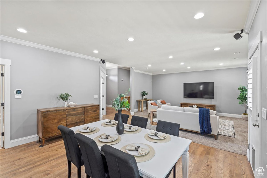 Dining space featuring crown molding, recessed lighting, and light wood finished floors