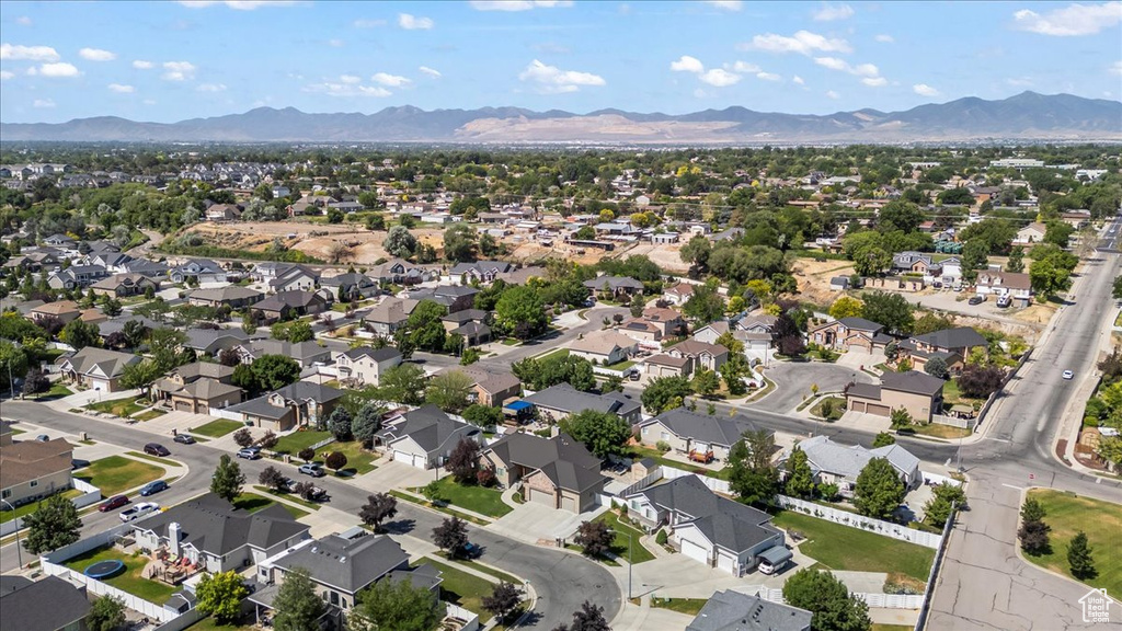 Aerial overview of property's location featuring mountains and nearby suburban area