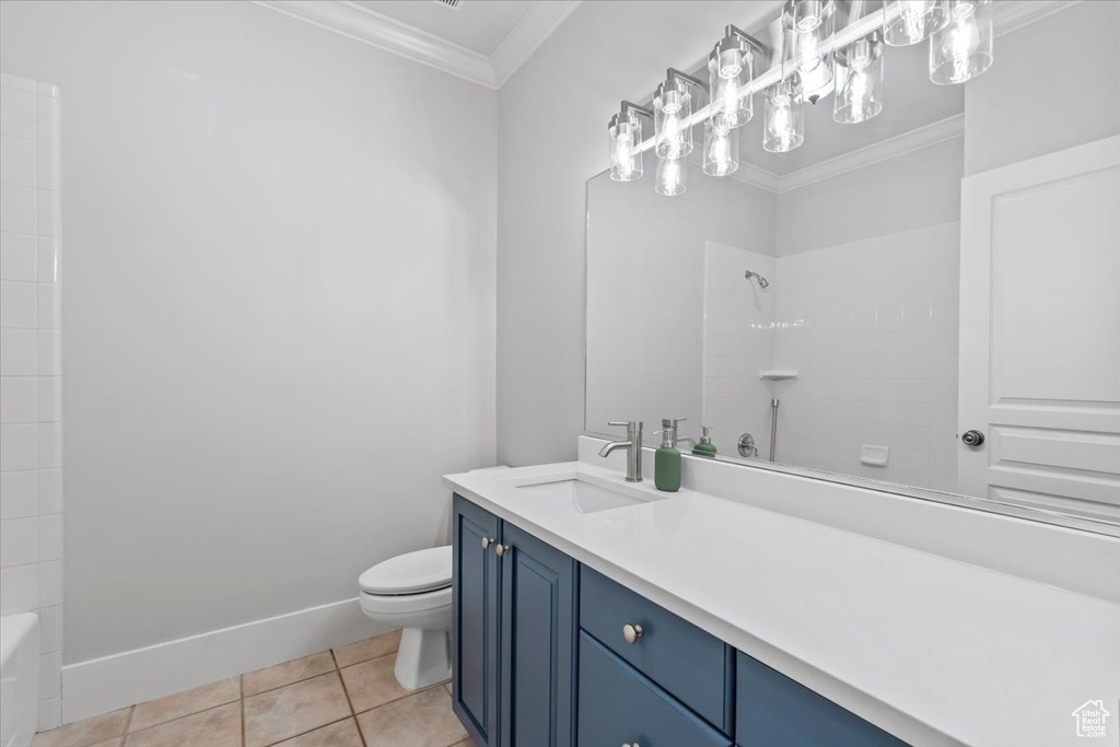 Full bath with crown molding, vanity, tile patterned floors, and bathtub / shower combination