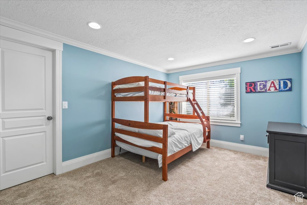 Bedroom featuring ornamental molding, carpet, a textured ceiling, and recessed lighting