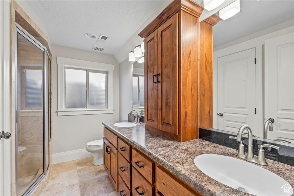Full bath featuring a stall shower and double vanity