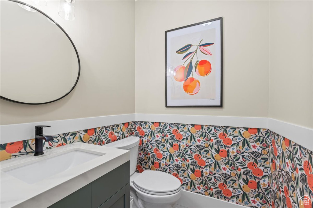 Half bathroom featuring toilet and vanity