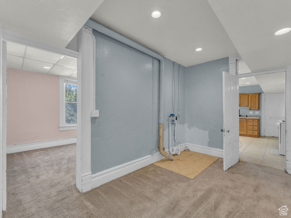 Basement with light colored carpet and recessed lighting