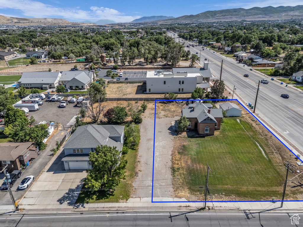 Aerial perspective of suburban area with property boundaries highlighted and mountains