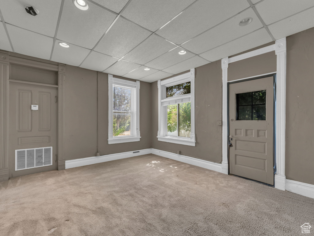 Foyer with carpet floors, recessed lighting, and a drop ceiling