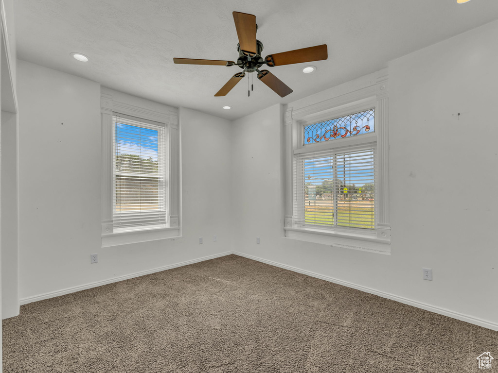 Carpeted empty room with recessed lighting and ceiling fan