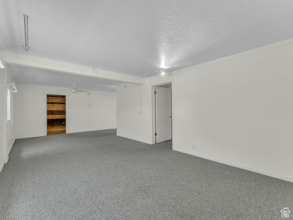 Carpeted spare room with baseboards and a textured ceiling