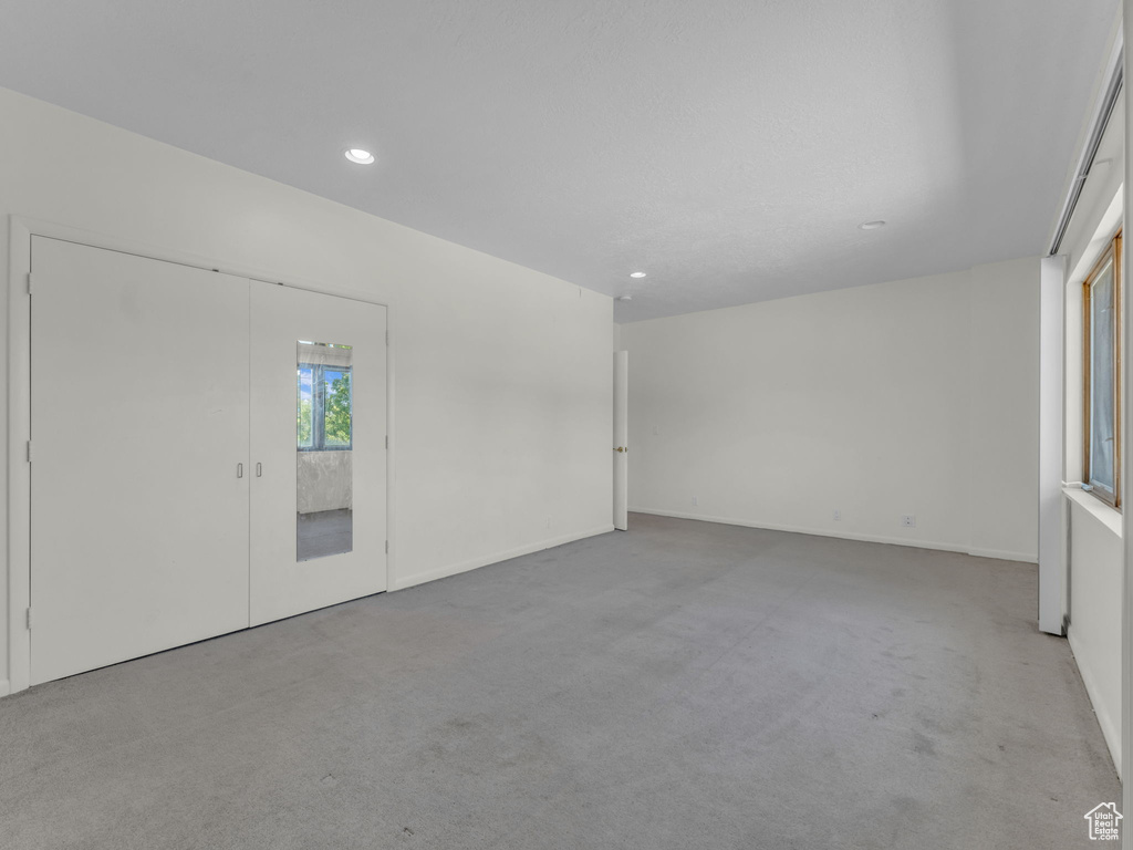 Carpeted spare room with recessed lighting