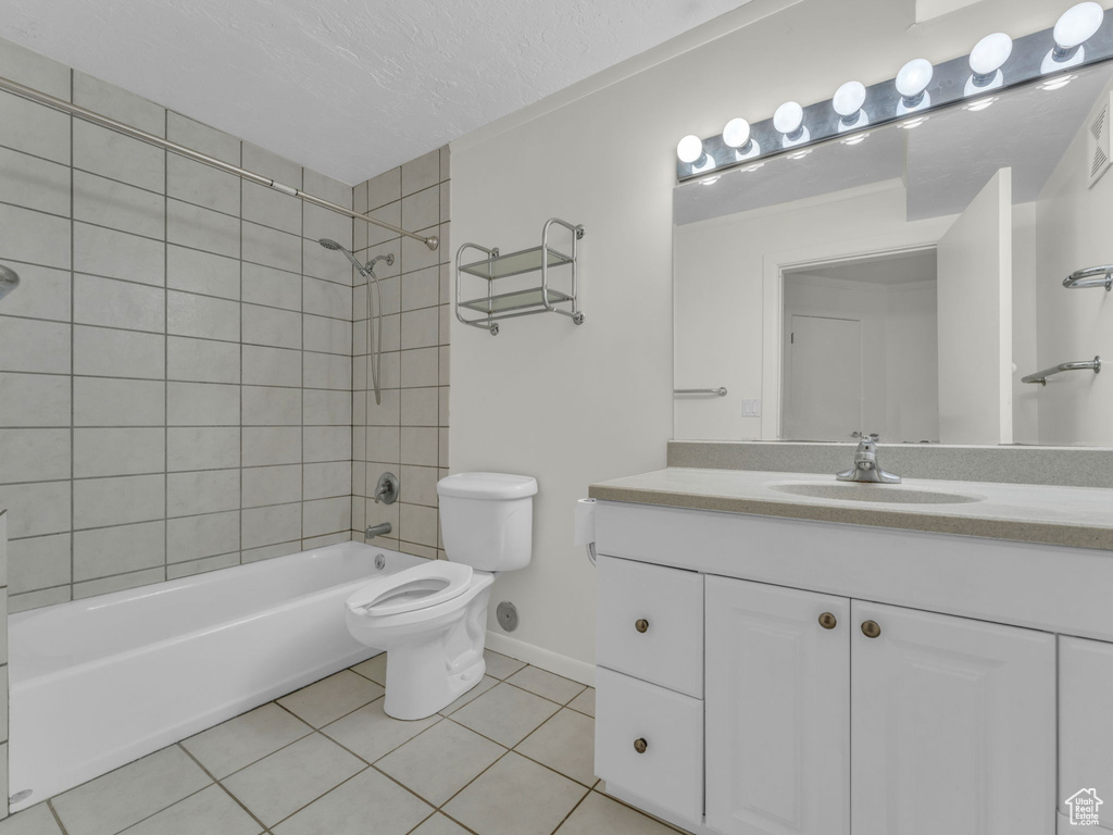Bathroom featuring tile patterned floors, vanity, and bathtub / shower combination
