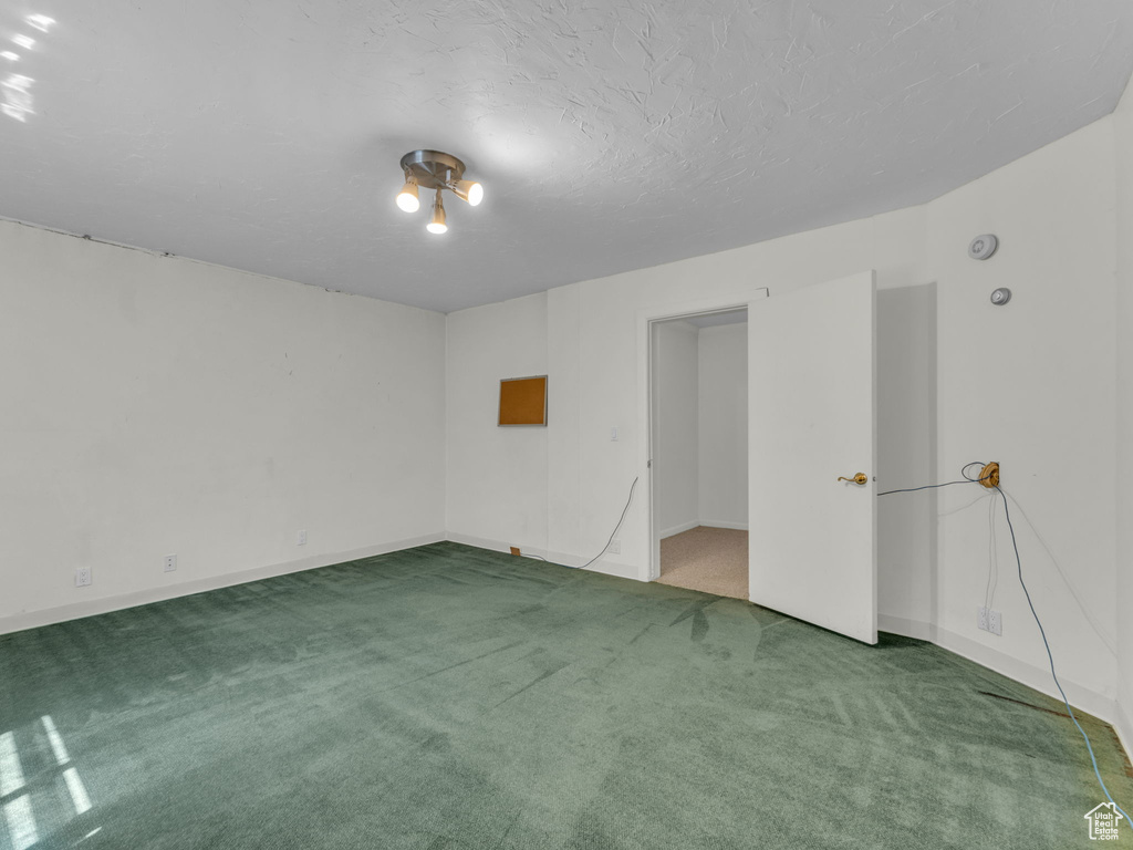 Empty room featuring carpet floors and baseboards