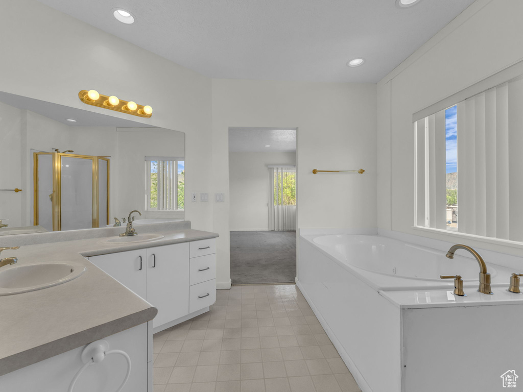 Full bath featuring vanity, a shower stall, a whirlpool tub, and recessed lighting