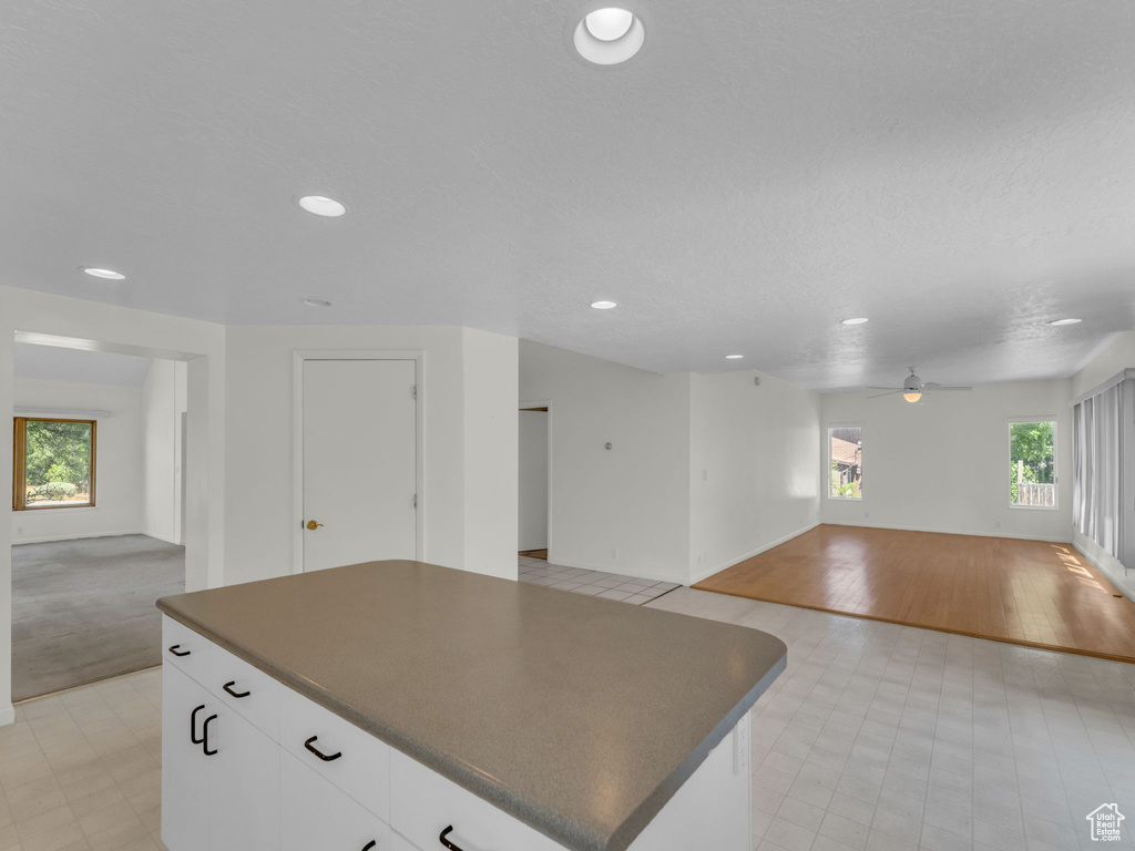 Kitchen featuring open floor plan, dark countertops, recessed lighting, and a center island