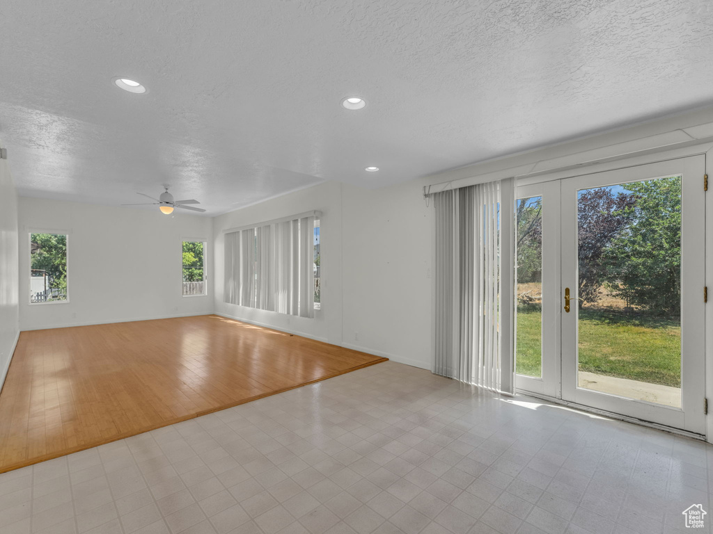 Empty room featuring ceiling fan, a textured ceiling, recessed lighting, and tile patterned flooring