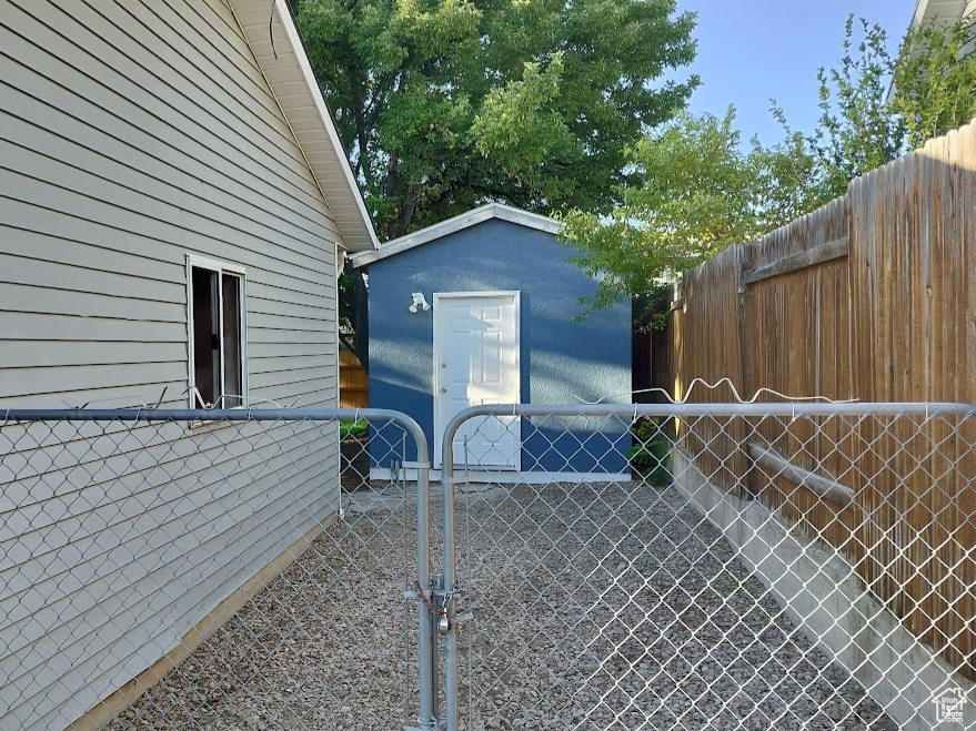 View of home\\\\\\\\\\\\\\\'s exterior with a gate and a storage shed