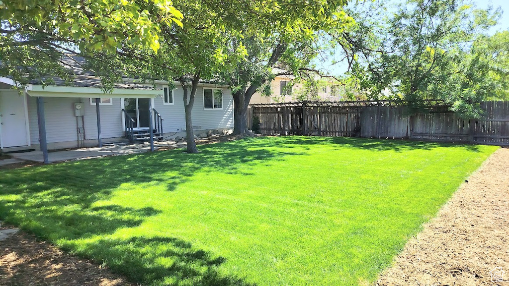 Fenced backyard featuring entry steps