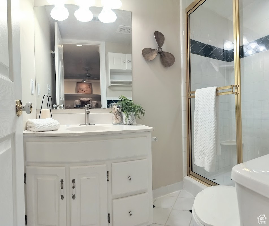 Bathroom with a stall shower, vanity, and tile patterned floors