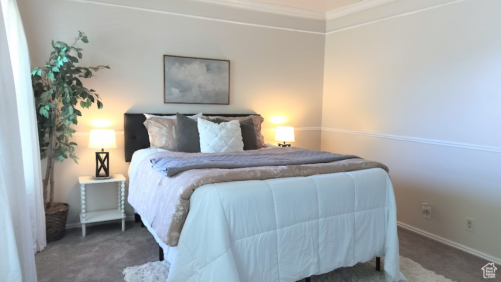 Bedroom featuring carpet flooring and crown molding