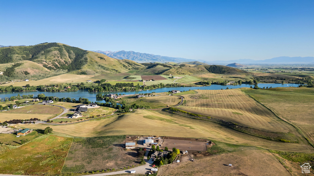 Aerial view of property's location with a water and mountain view