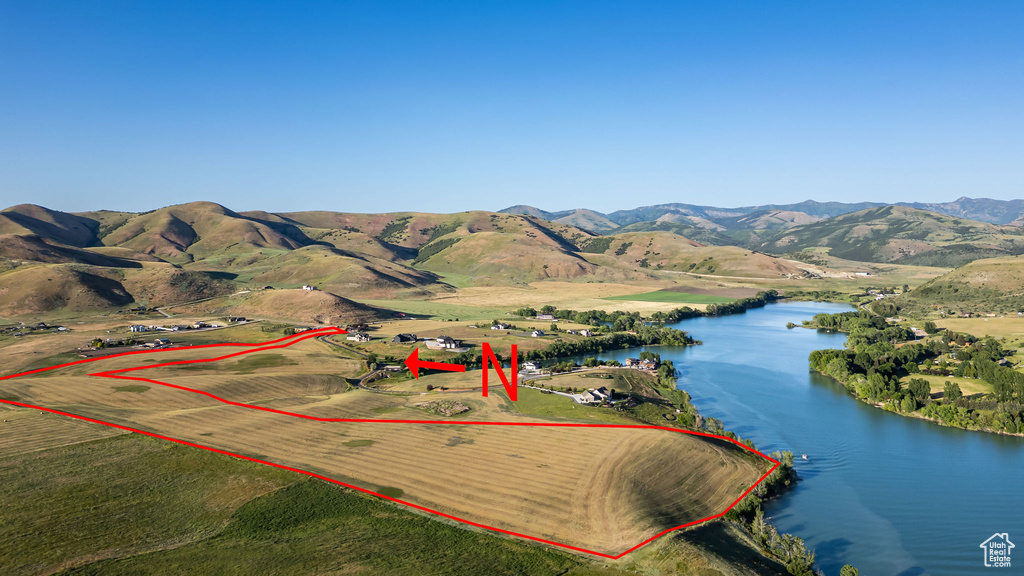 Aerial view of property's location featuring a water and mountain view and property parcel outlined