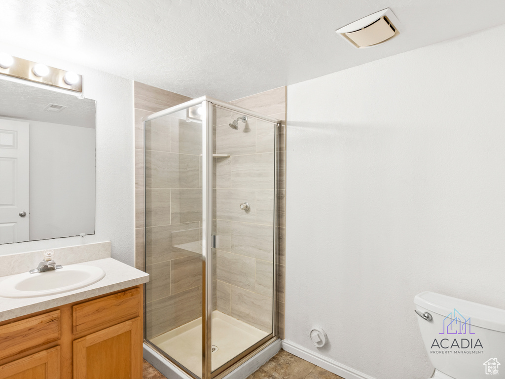 Full bathroom with vanity and a shower stall