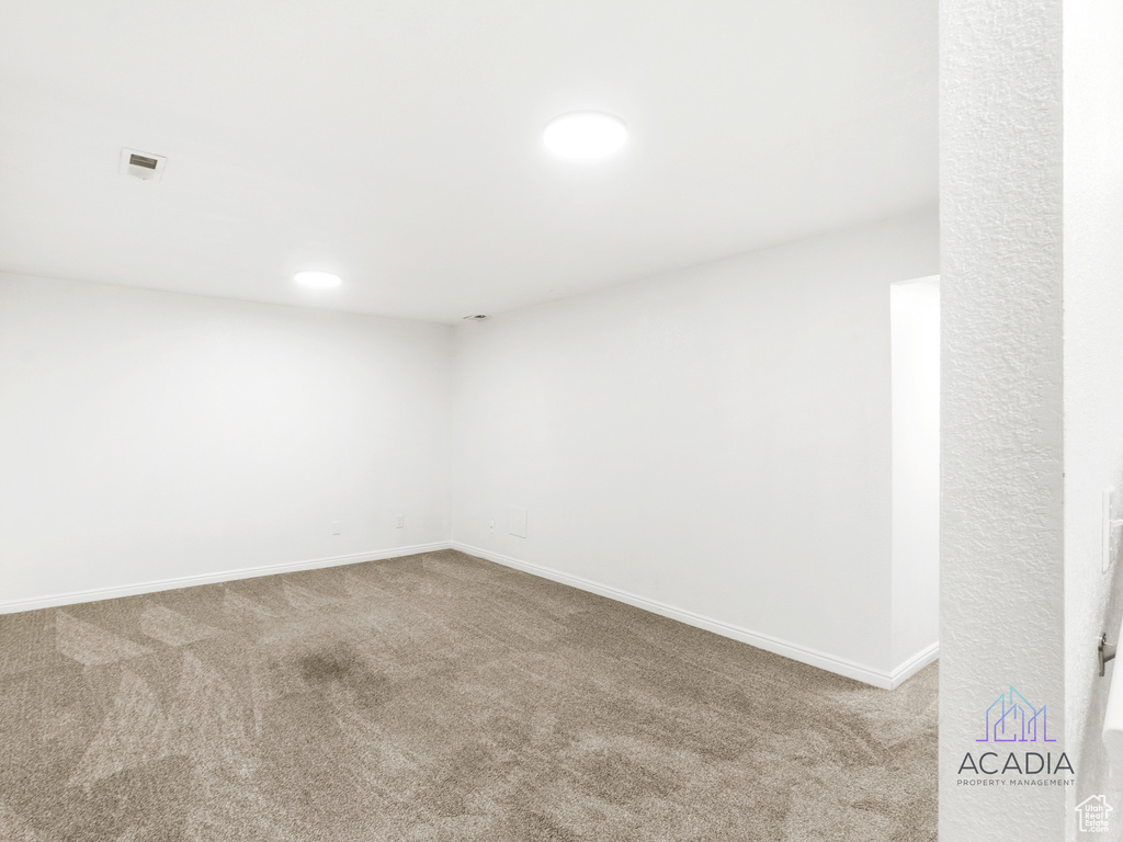 Carpeted spare room with baseboards