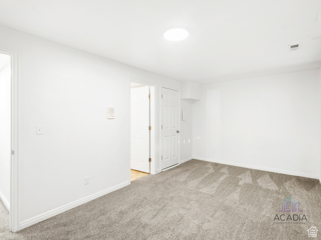 Carpeted empty room with baseboards
