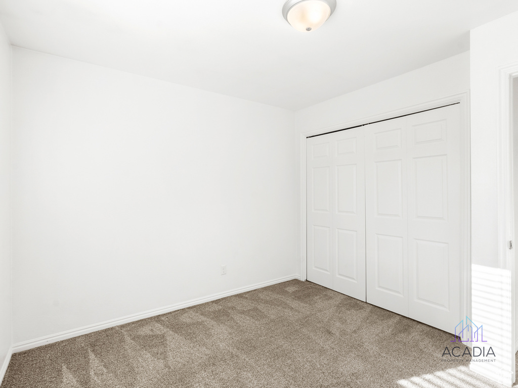 Unfurnished bedroom featuring carpet and a closet