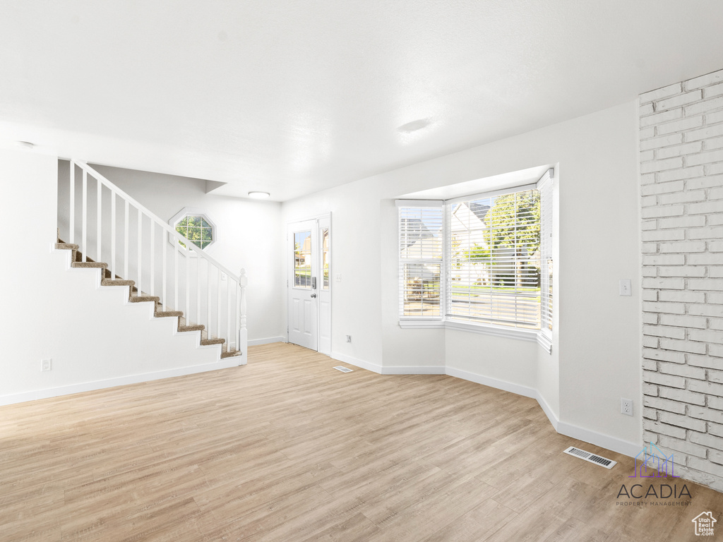Foyer with light wood-style flooring and stairway