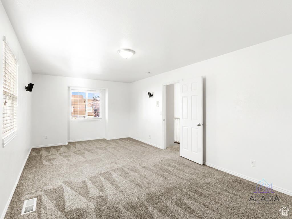 Carpeted empty room with baseboards