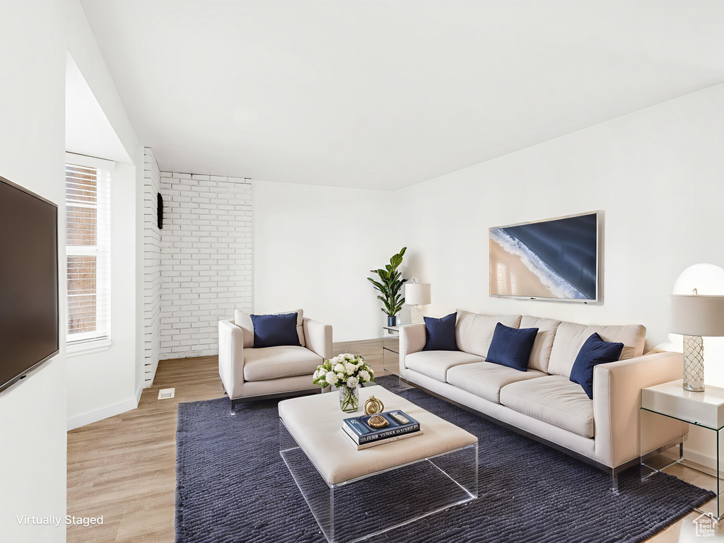 Living area with light wood-style floors and baseboards