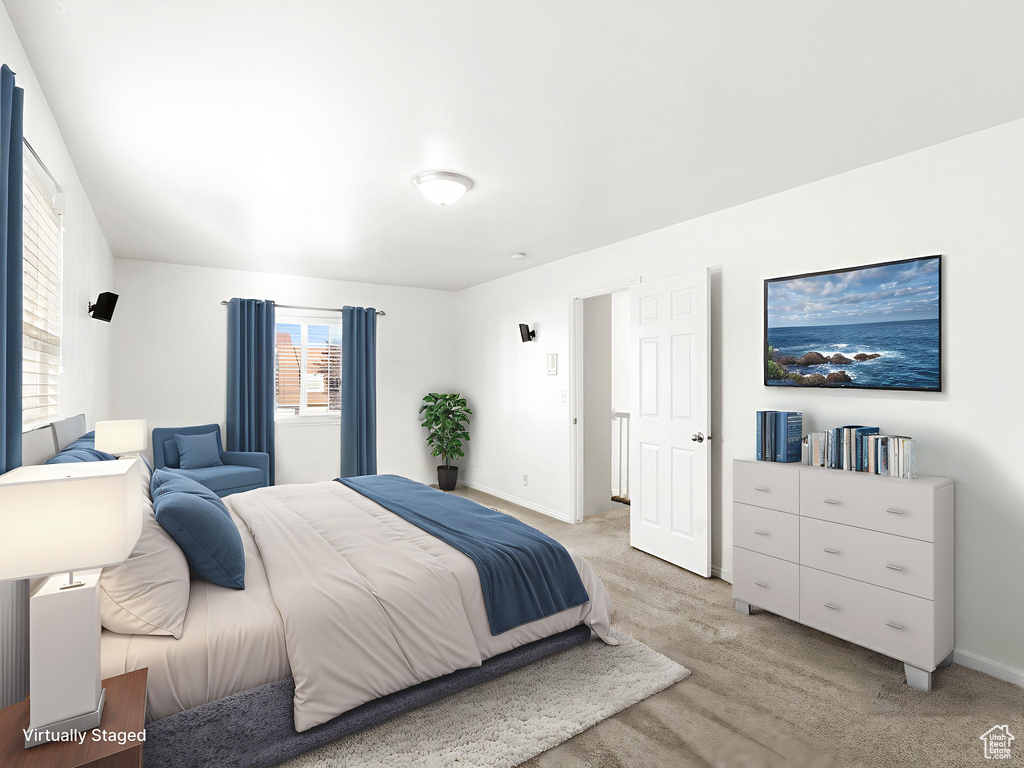 Bedroom featuring light colored carpet and baseboards