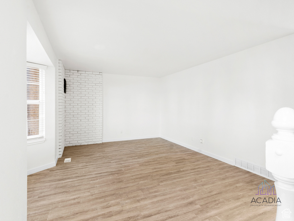 Unfurnished room featuring light wood-style floors and baseboards