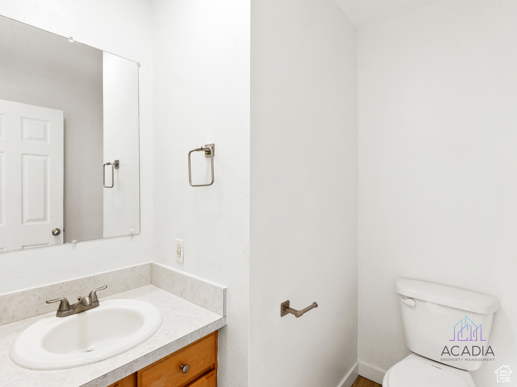 Half bathroom with toilet and vanity