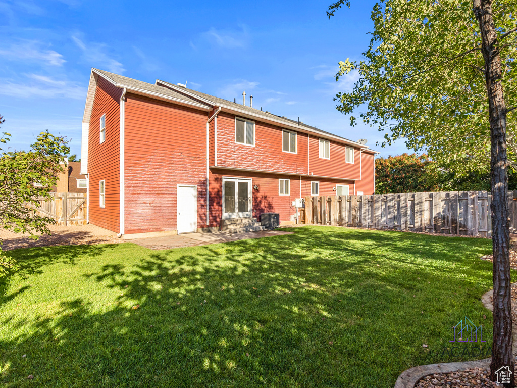 Back of property with a patio
