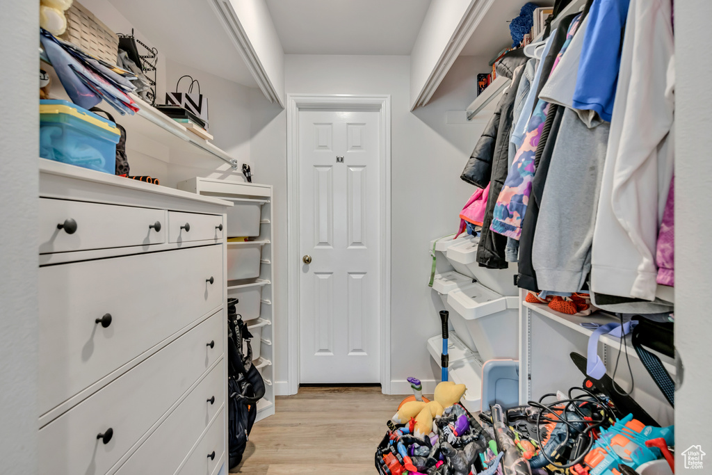 Walk in closet featuring light wood-style floors