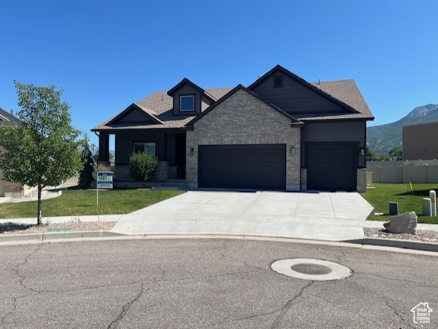 View of front of property featuring an attached garage and concrete driveway