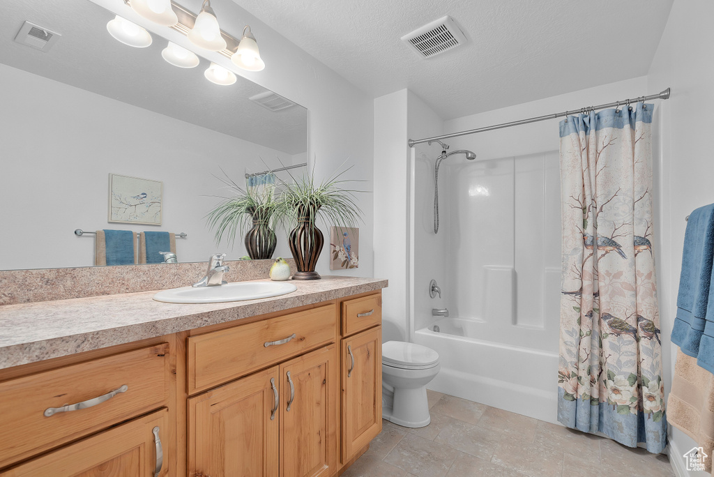 Bathroom featuring vanity and shower / tub combo with curtain